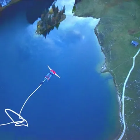 A jumper on the rope above the lake at Stockhorn