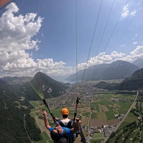 A tandem paraglider above the Interlaken valley