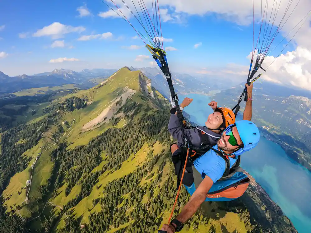 A tandem alongside a grassy summit ridge