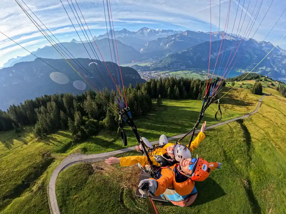 A tandem lifting off above the green pasture