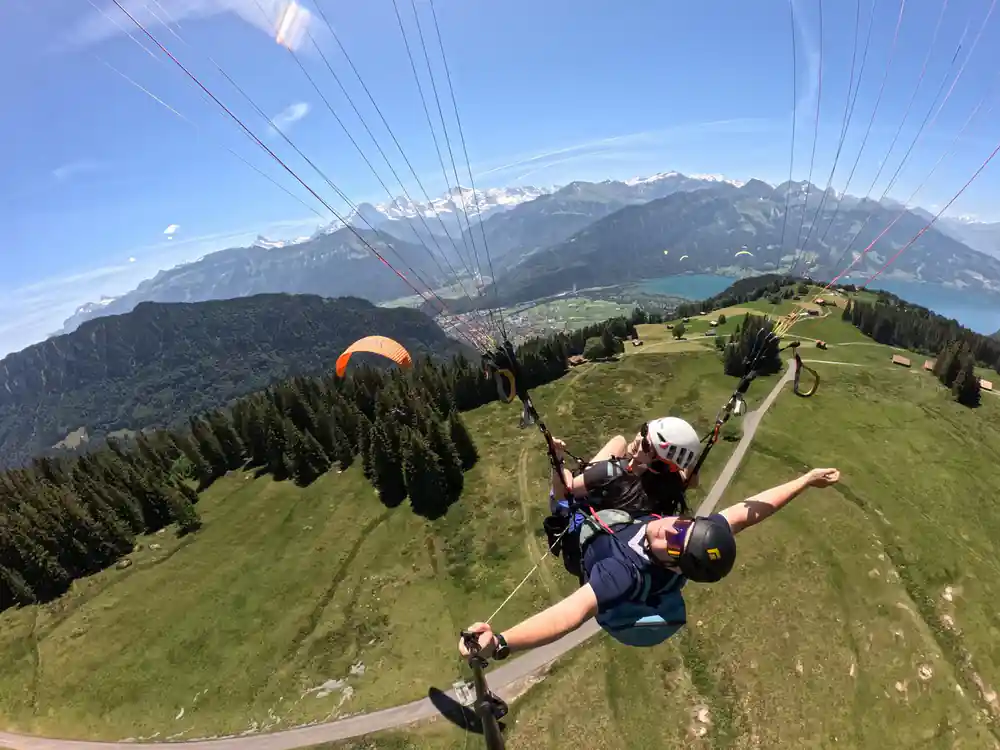 A wing over the green valley with the lake beyond